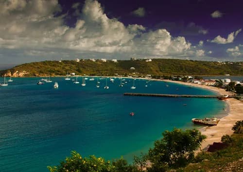 Boats anchored in the blue water of Sandy Ground Bay in Anguilla