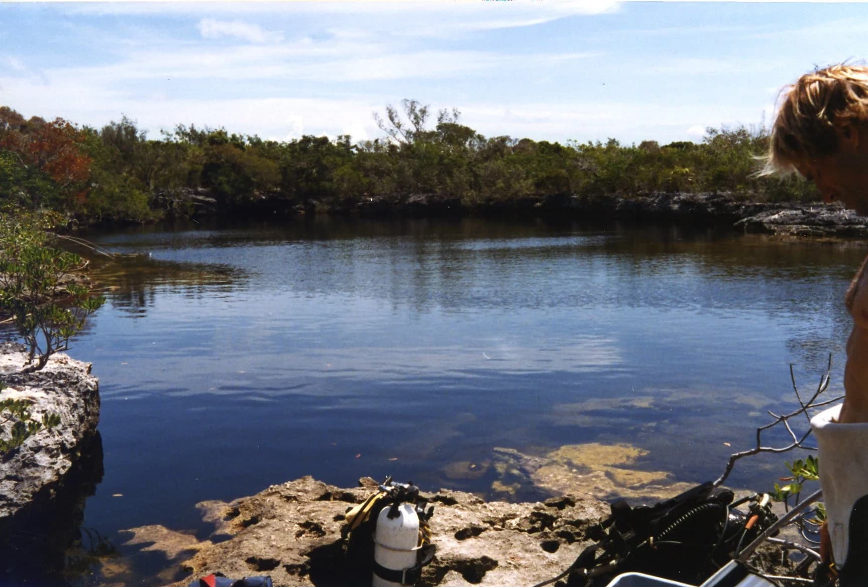 Guardian Blue Hole on Andros Island in the Bahamas, ringed by low vegetation and limestone