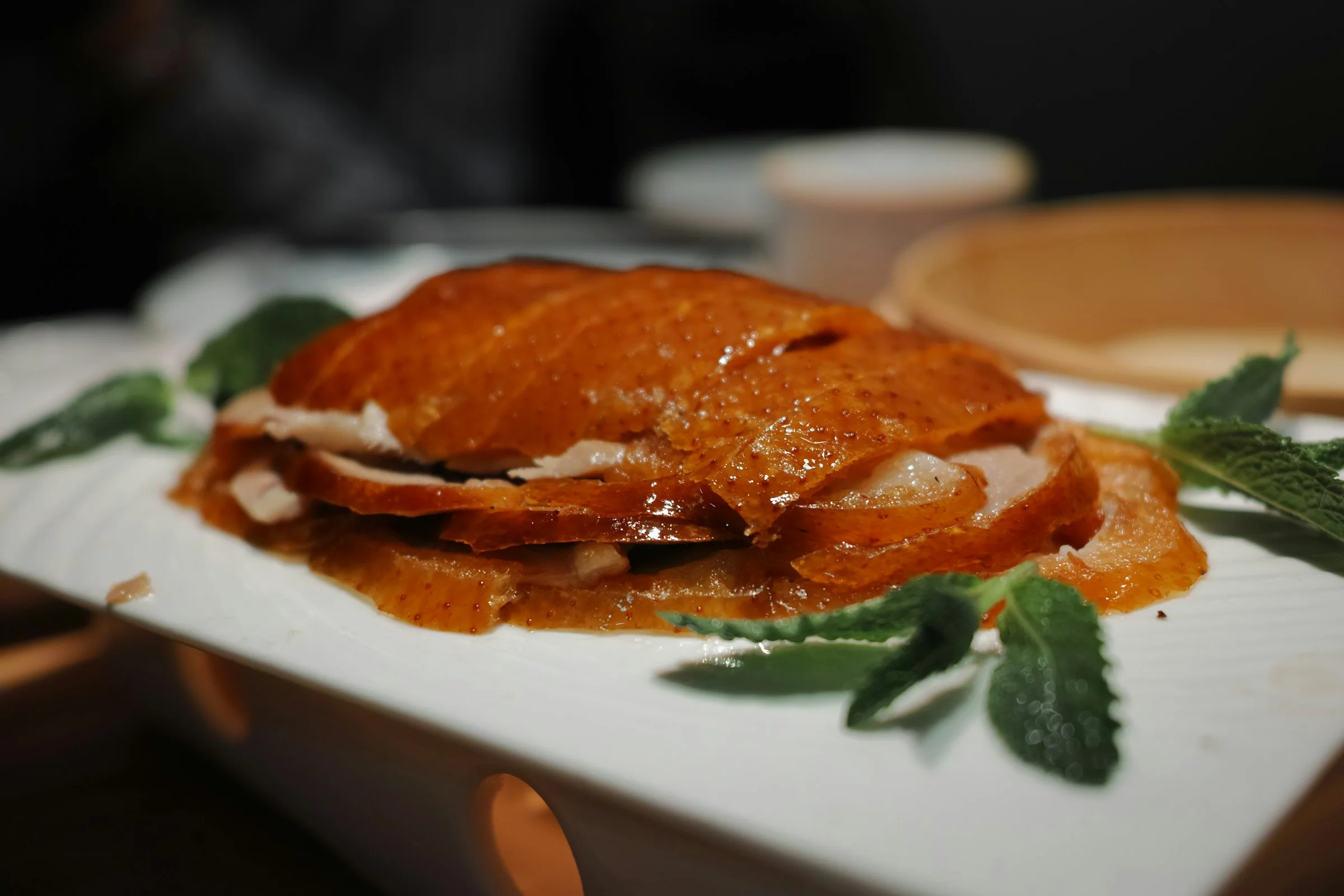 Sliced roasted Peking duck arranged on a plate