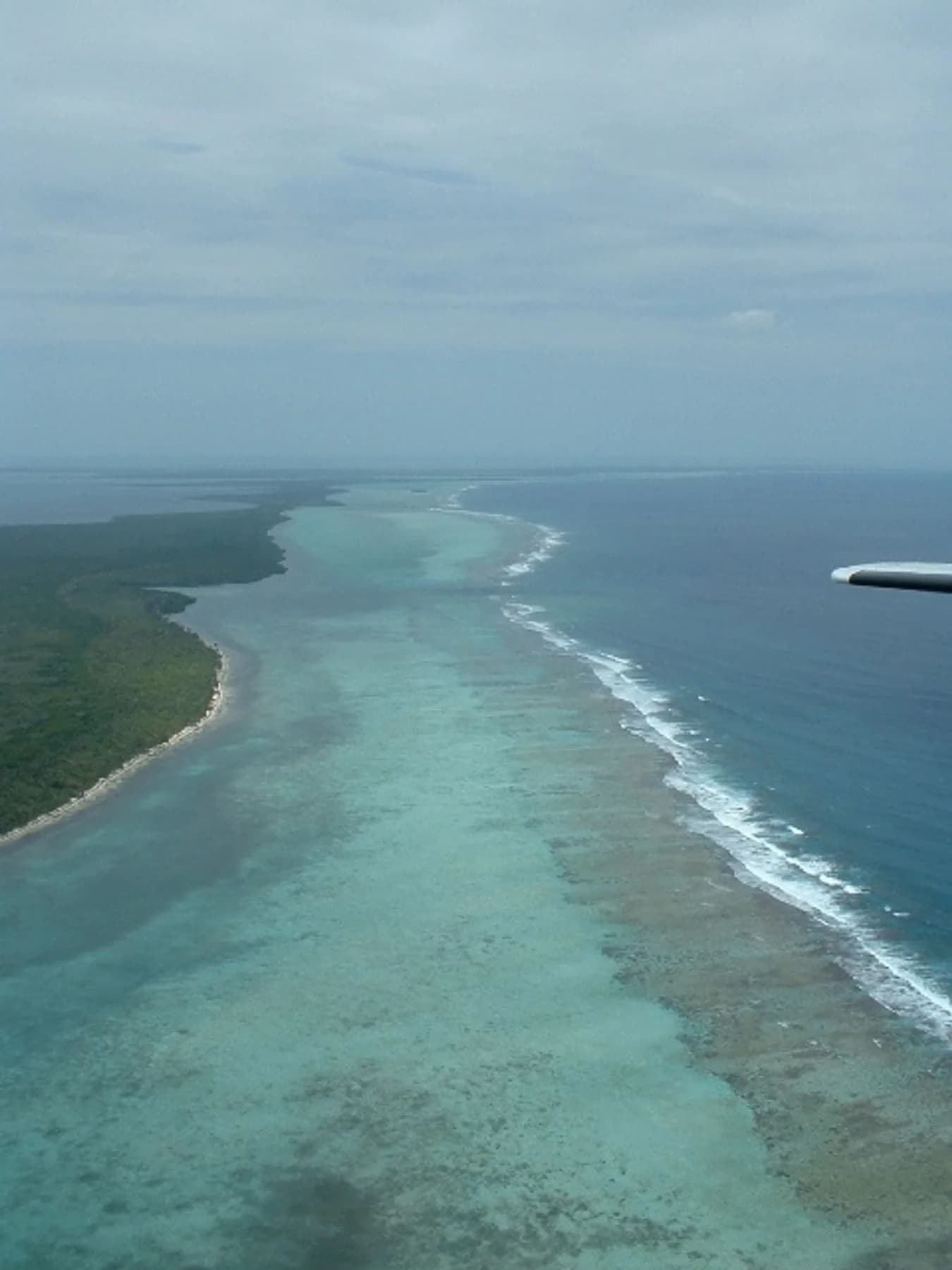 Aerial view of the Belize Barrier Reef running beside the coast