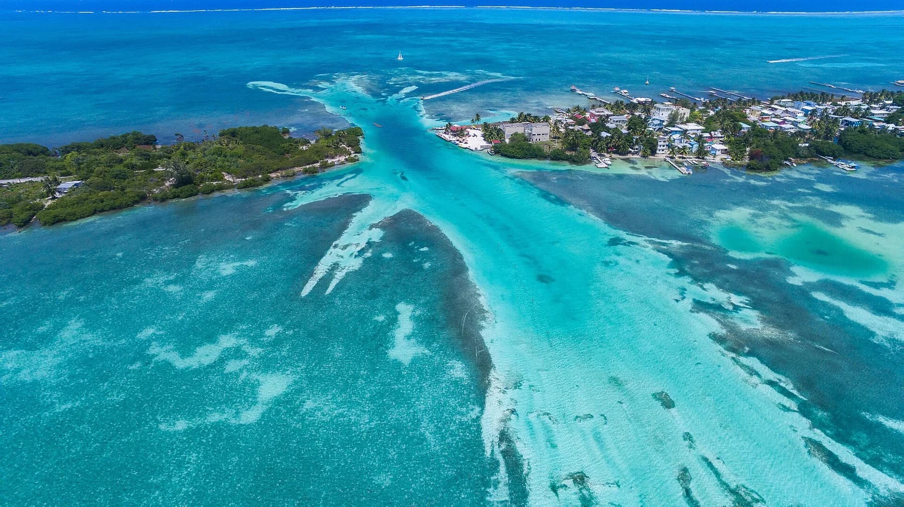 Aerial view of turquoise water and the settlement on Caye Caulker