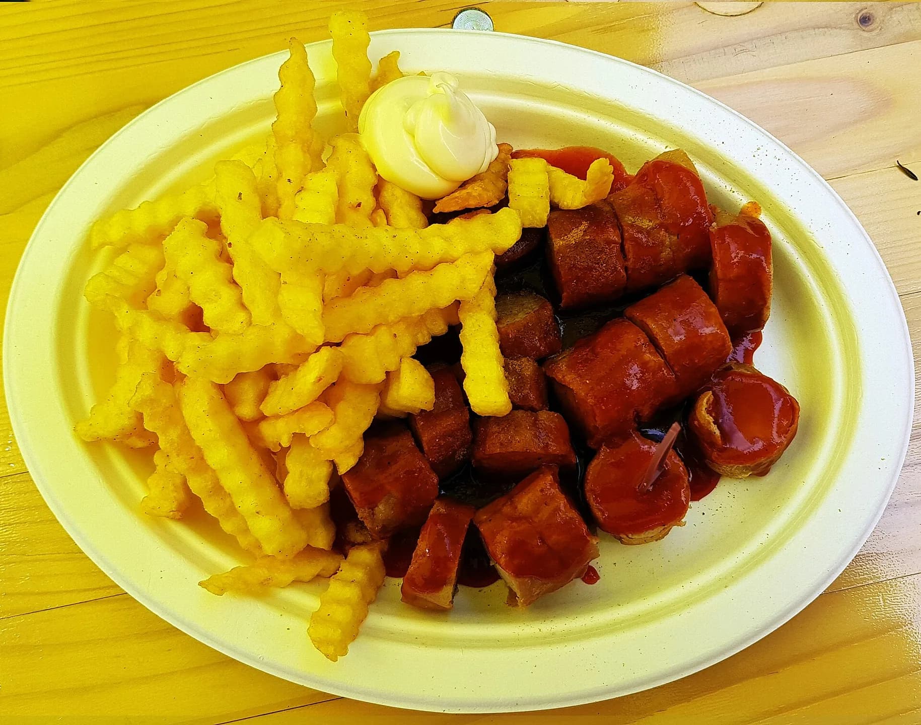 Berlin currywurst served with crinkle-cut fries and mayonnaise