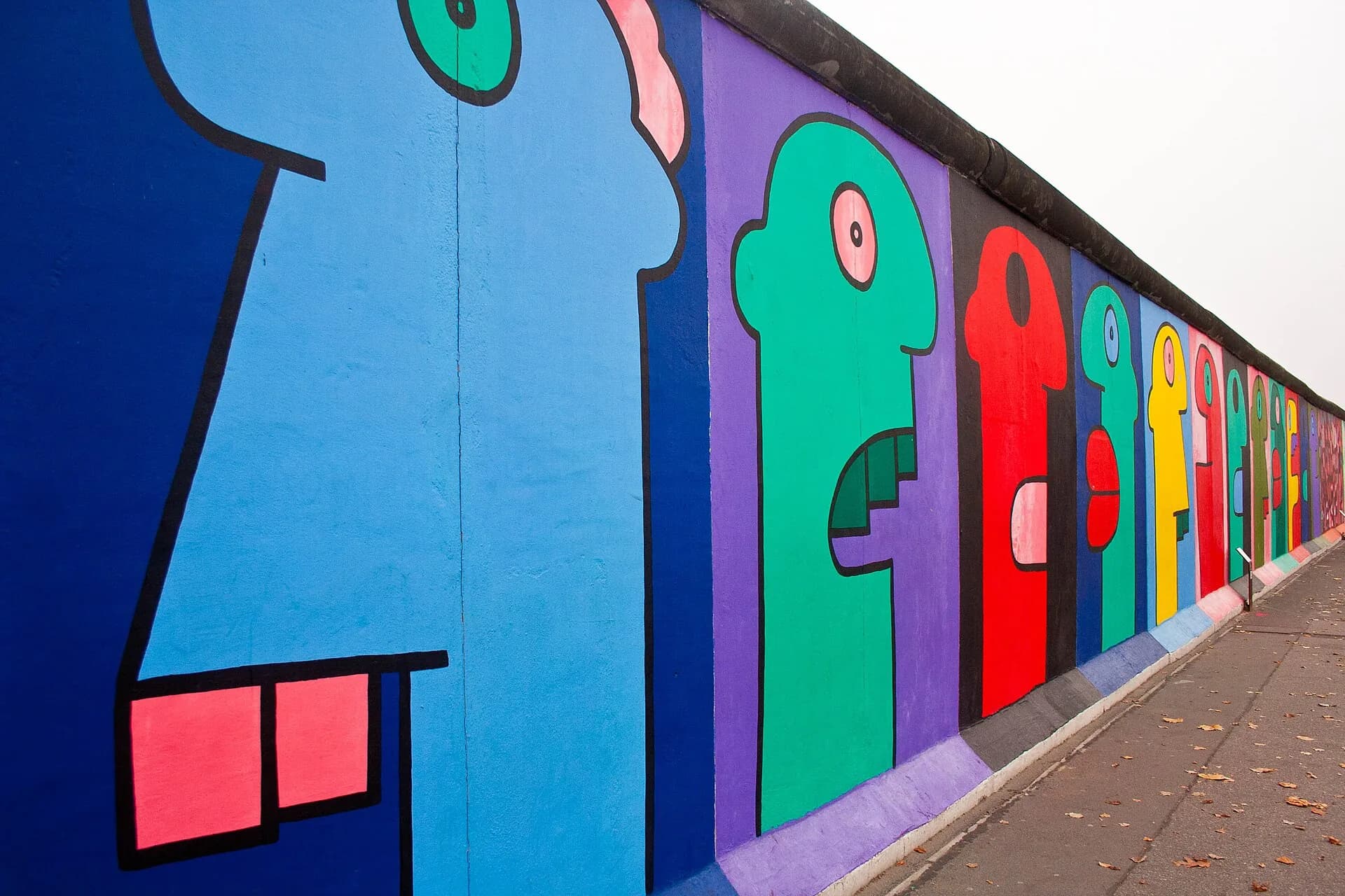 Thierry Noir's colorful mural figures along Berlin's East Side Gallery