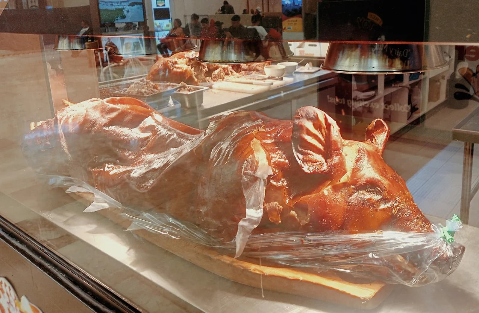 Whole roasted Cebu lechon with crisp skin displayed for serving