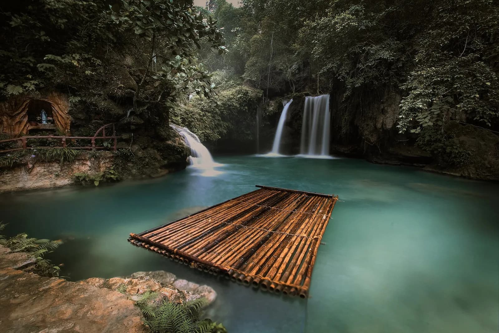 Turquoise pools, waterfalls, and a bamboo raft at Kawasan Falls in Badian, Cebu