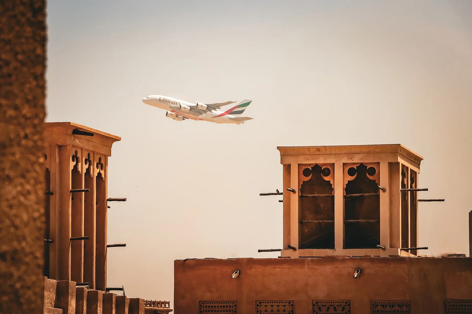 Traditional wind towers and earth-toned buildings in Al Fahidi, Dubai