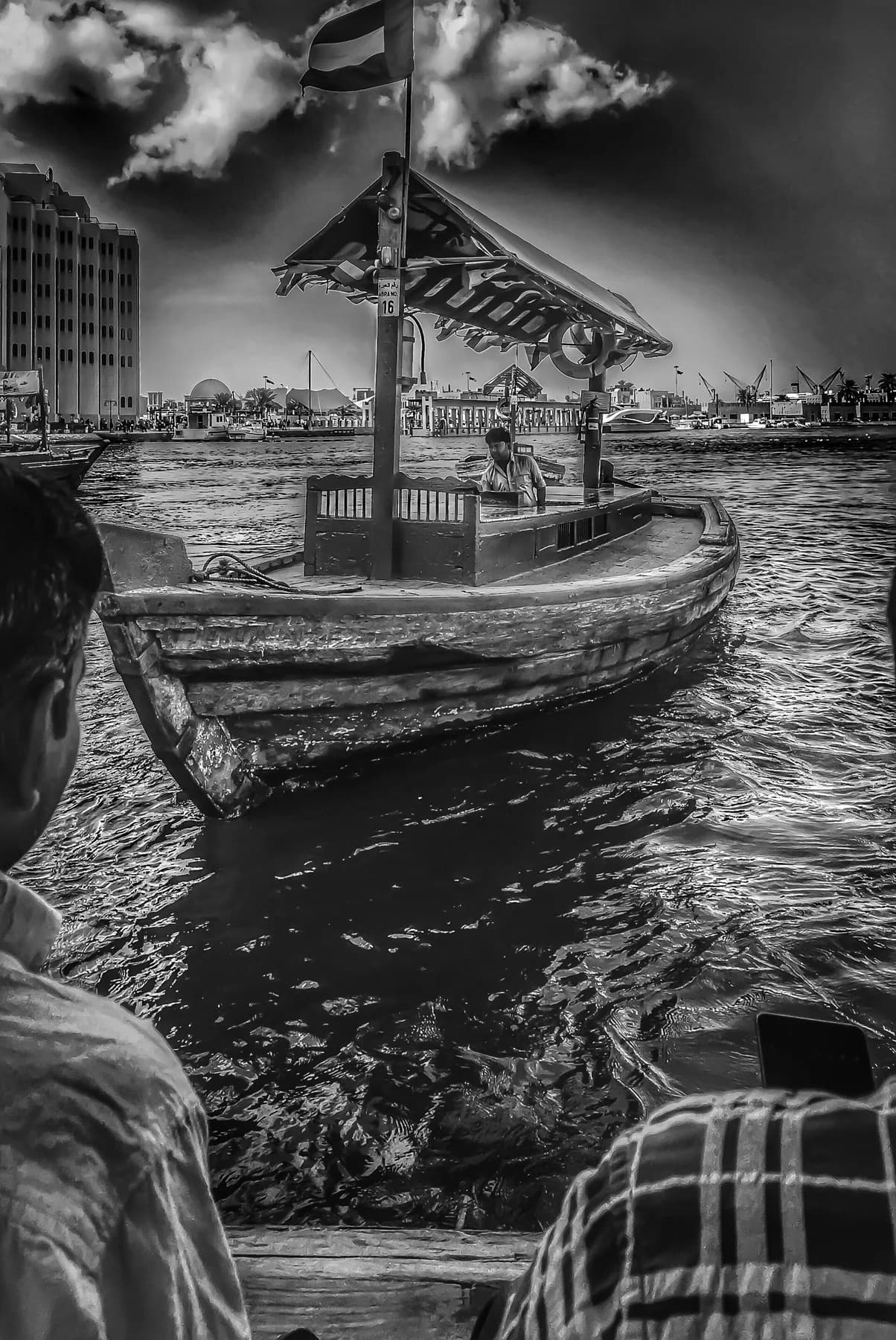 Traditional wooden abra crossing Dubai Creek in Old Dubai