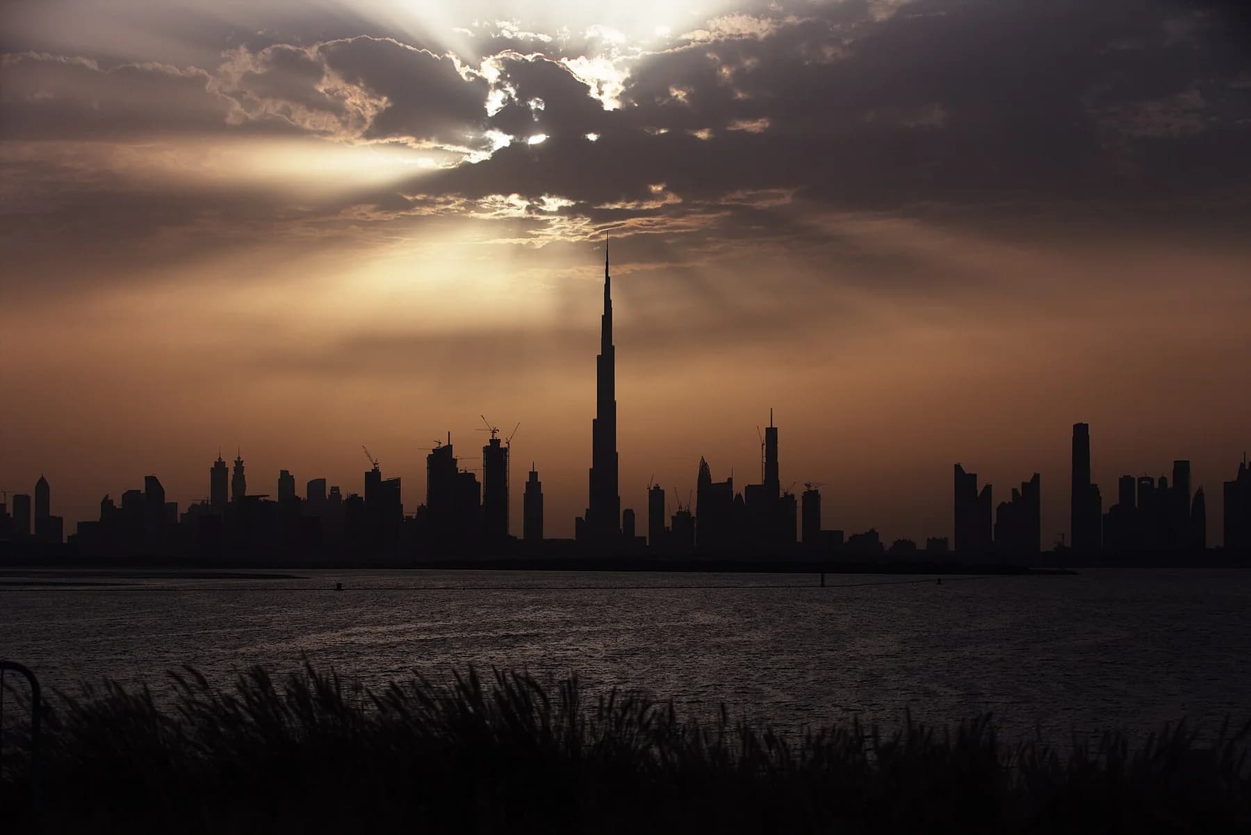 Burj Khalifa rising above the Dubai skyline at sunset