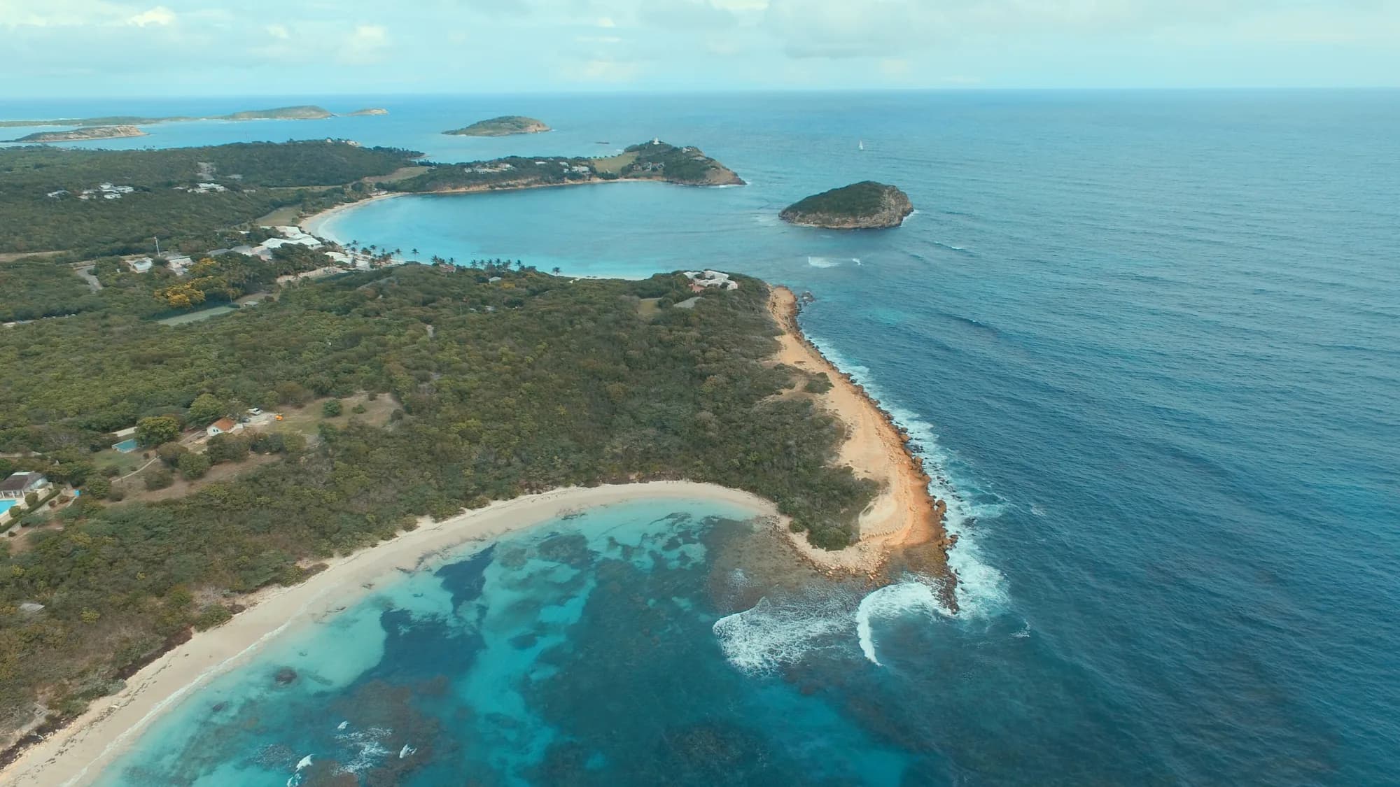Aerial view of Half Moon Bay and Exchange Bay on Antigua's Atlantic coast