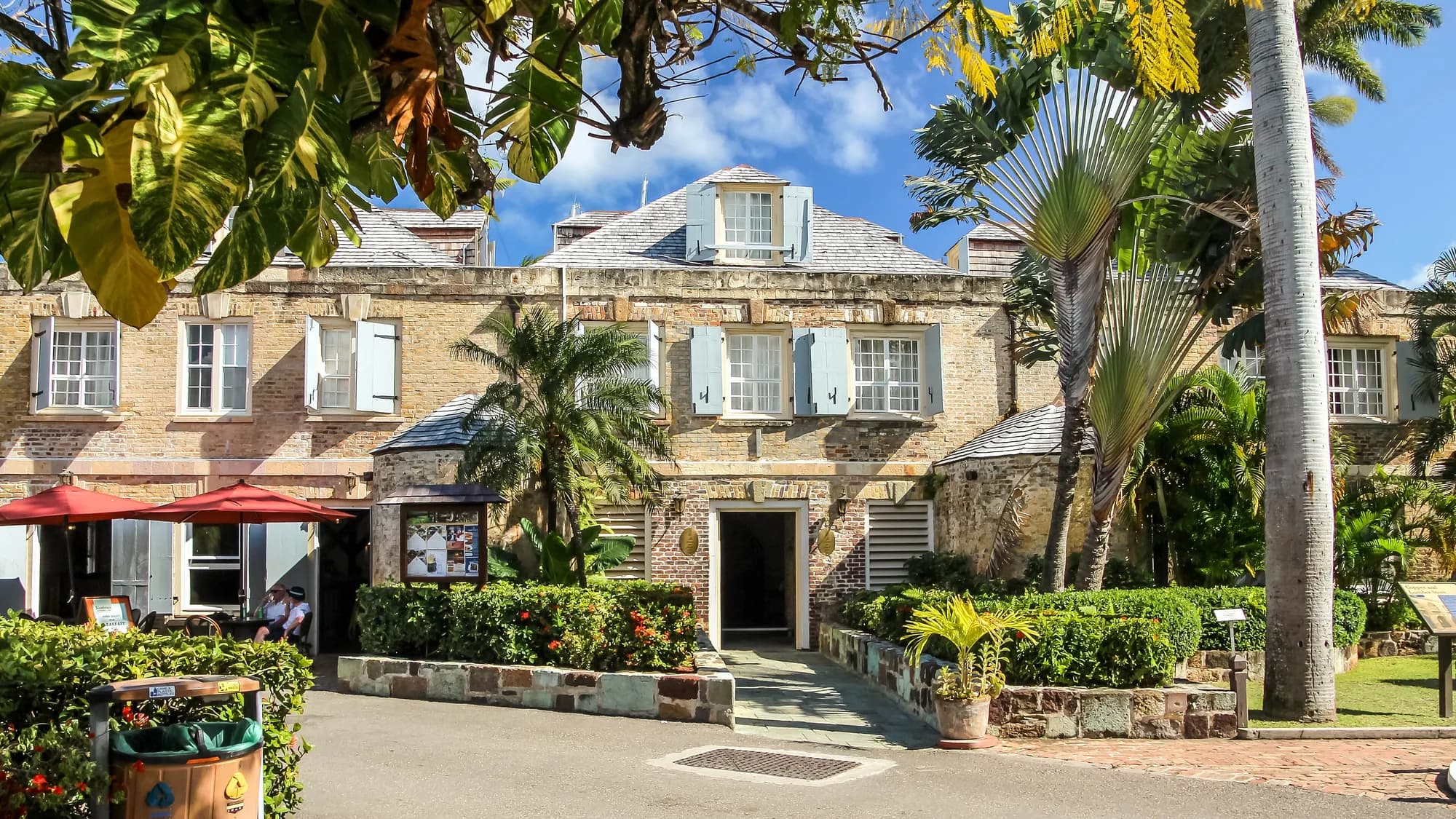 Historic stone building and palm trees at Nelson's Dockyard in English Harbour, Antigua