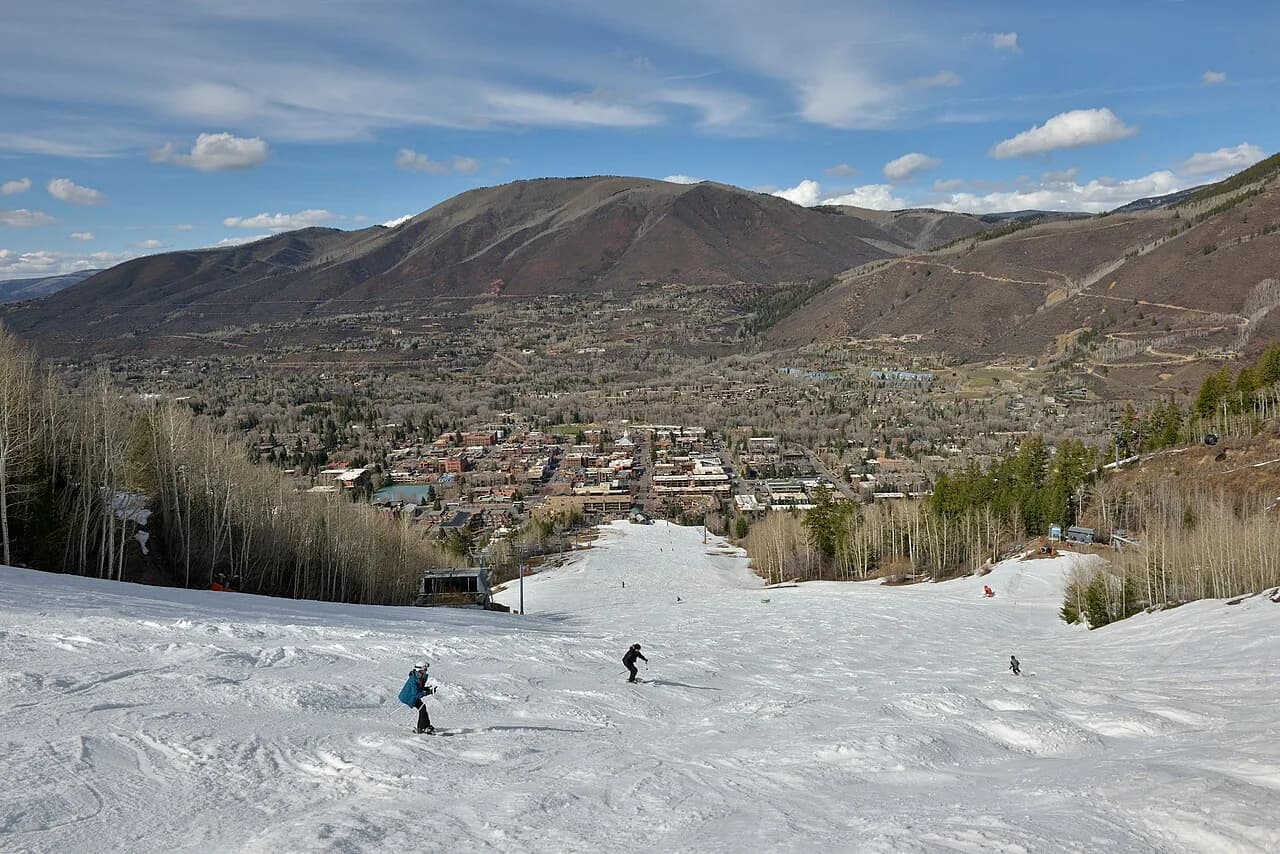 Skiers descending Aspen Mountain toward the town of Aspen, Colorado