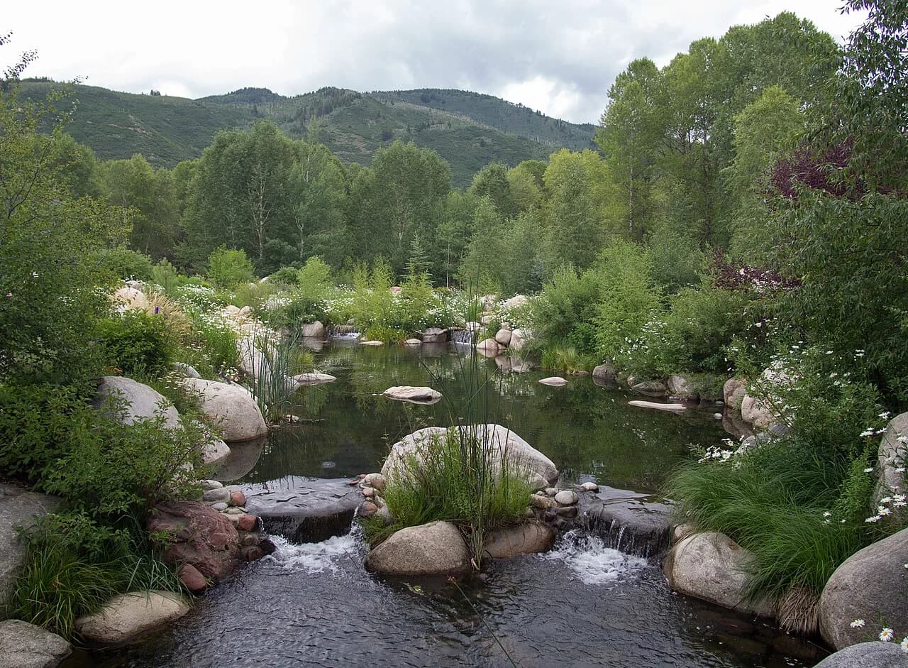 Flowering gardens, rocks, and a stream at the John Denver Sanctuary in Aspen