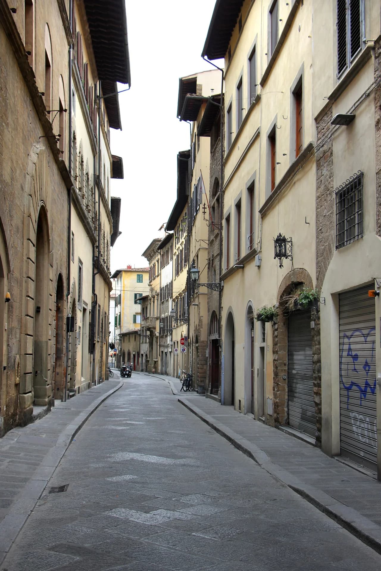 Narrow stone-lined Via Santo Spirito in Florence's Oltrarno neighborhood
