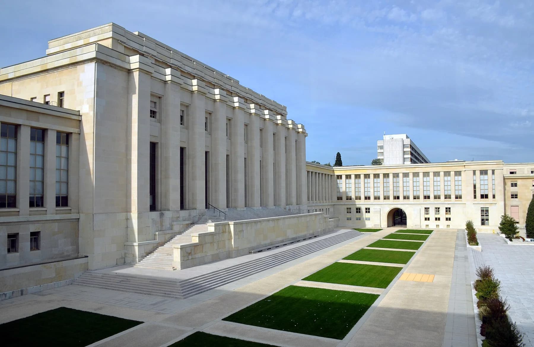 Pale stone façades and formal grounds at the Palais des Nations in Geneva